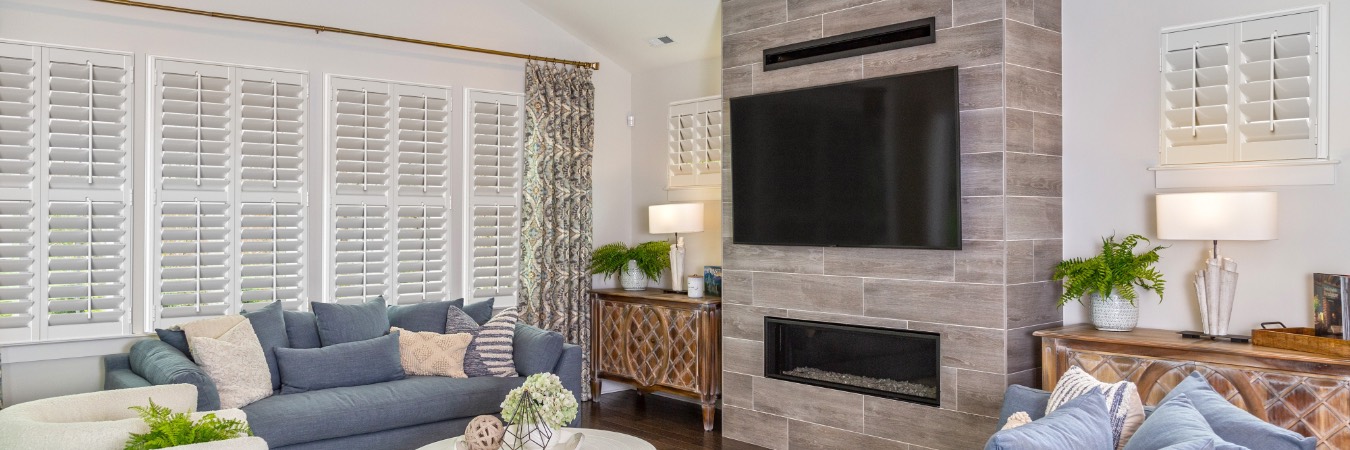 Plantation shutters in Long Neck family room with fireplace